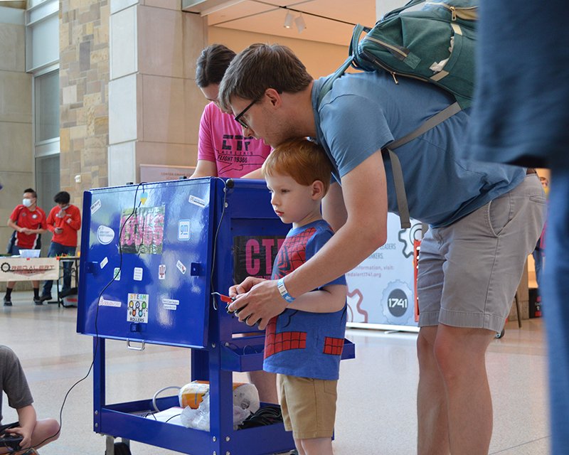 family engaging with activity at tinkerfest