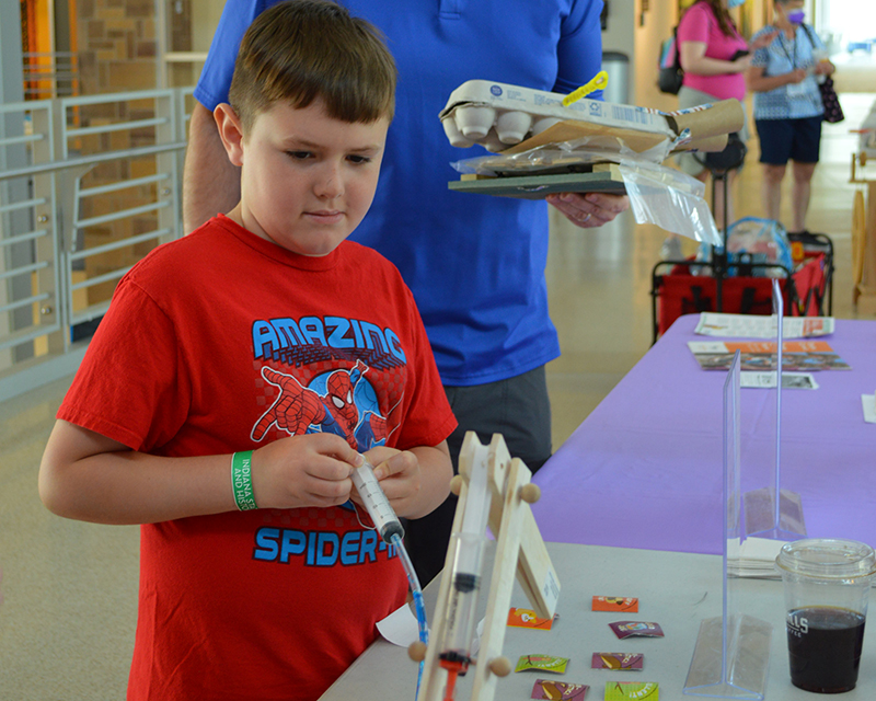child engaging with activity at tinkerfest
