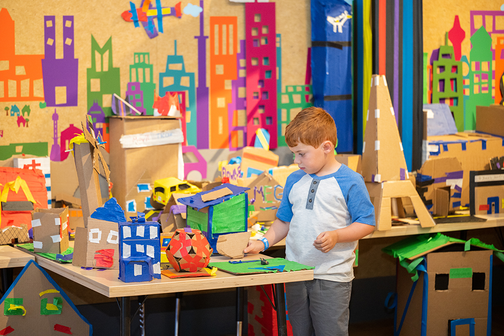 Child playing in Cardboard Engineering exhibit