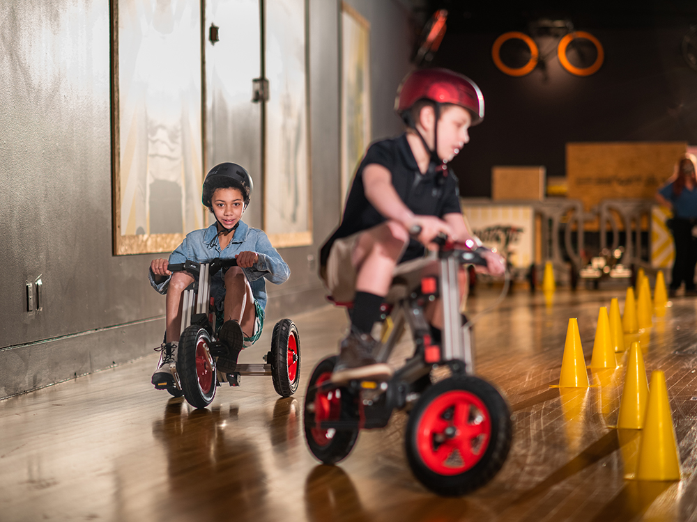 Children riding bikes in Major Taylor exhibit