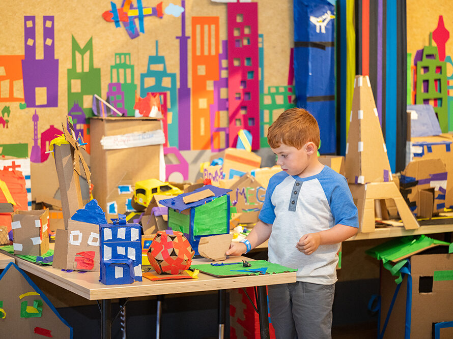Child playing in Cardboard Engineering exhibit