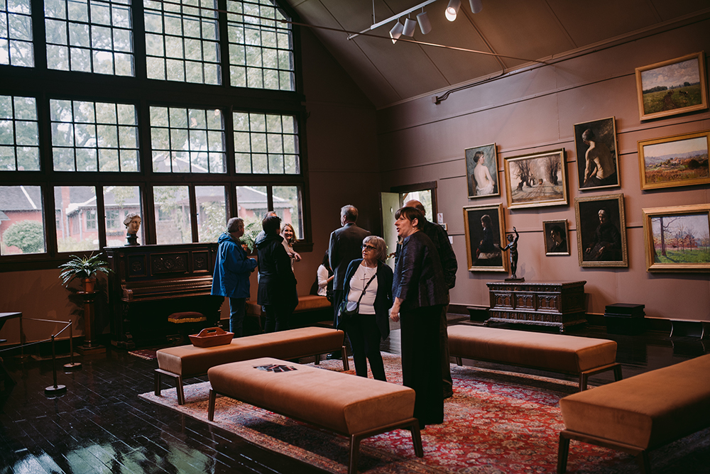 Visitors standing inside Large Studio at T.C. Steele State Historic Site