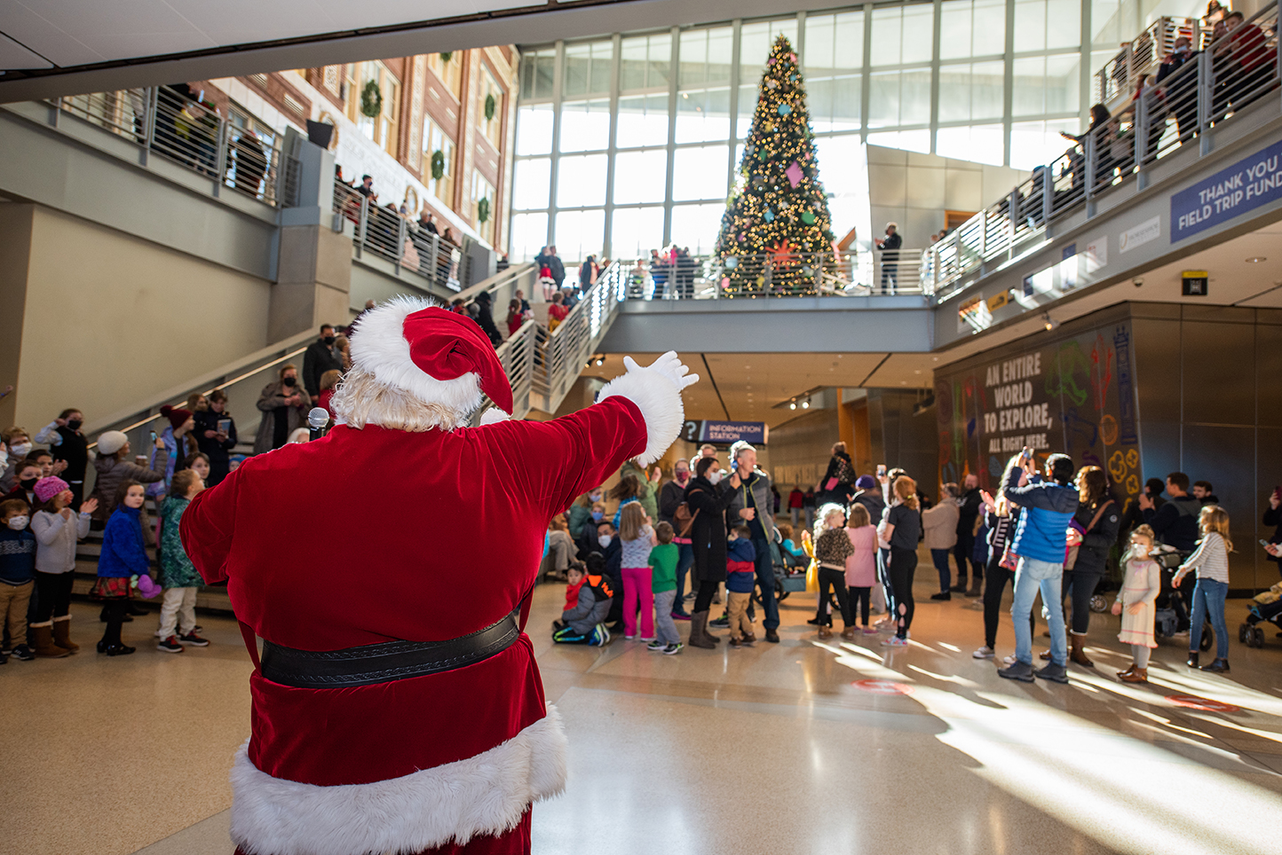 Santa standing in front of visitors in the Great Hall at the Indiana State Museum