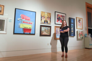 Meredith McGovern posing in front of gallery wall