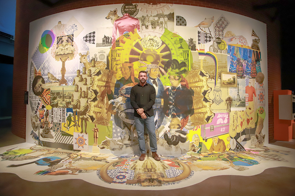 Artur Silva standing in front of mural