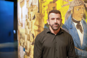 Artur Silva standing in front of mural