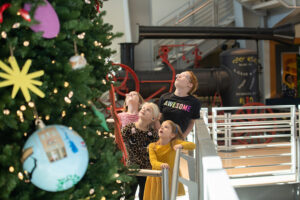 children looking up at 92 county tree