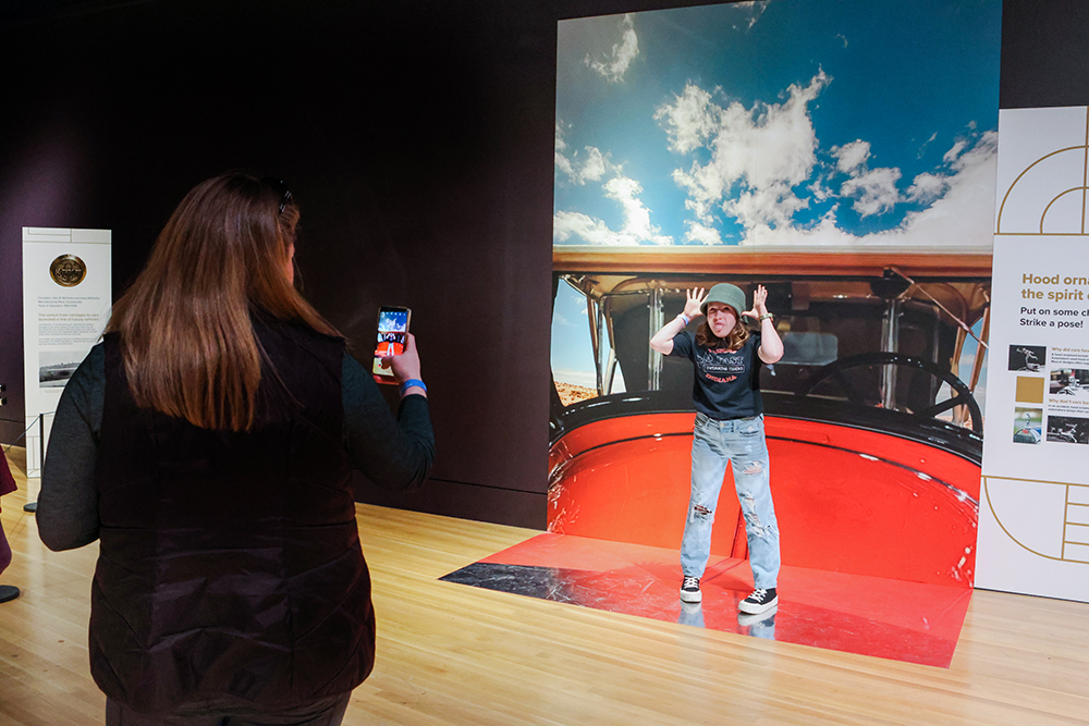 Teenager posing in front of photo backdrop