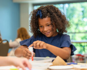 camper making activity at table