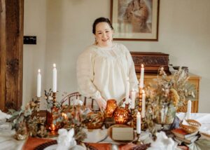 Woman standing around a table with candles