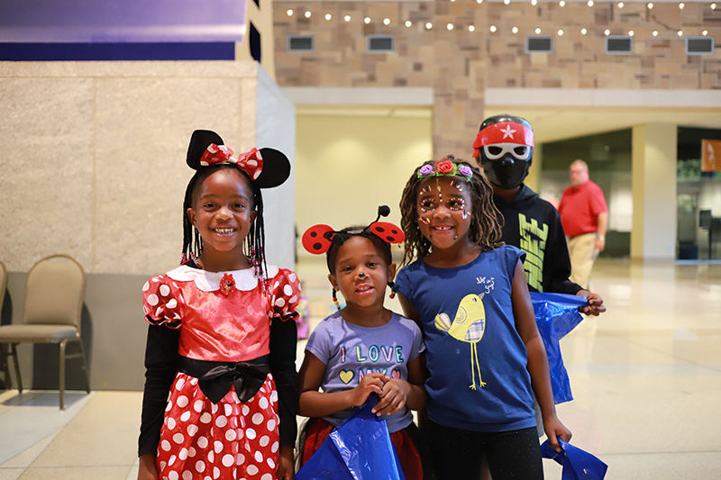 three girls in halloween costumes posing for a picture