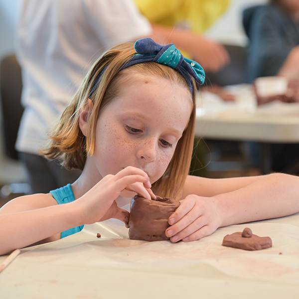 girl making clay pot