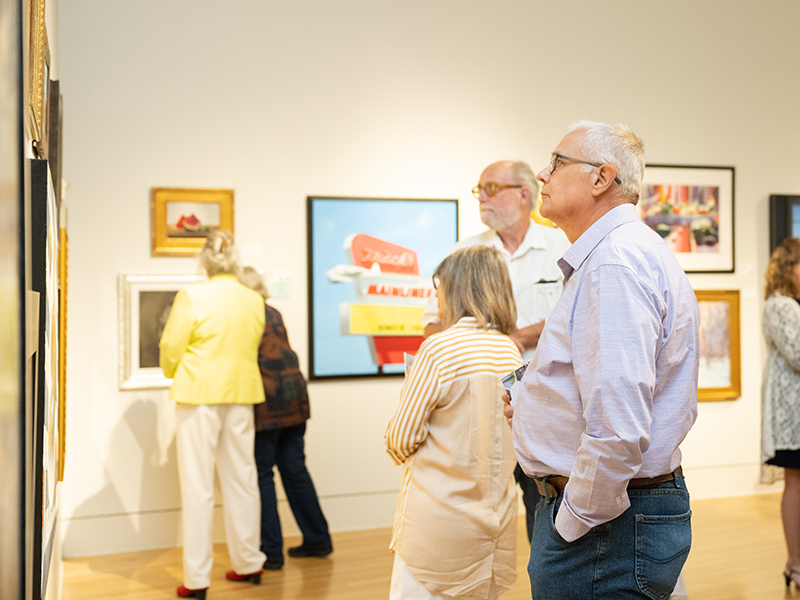 man looking at art in gallery