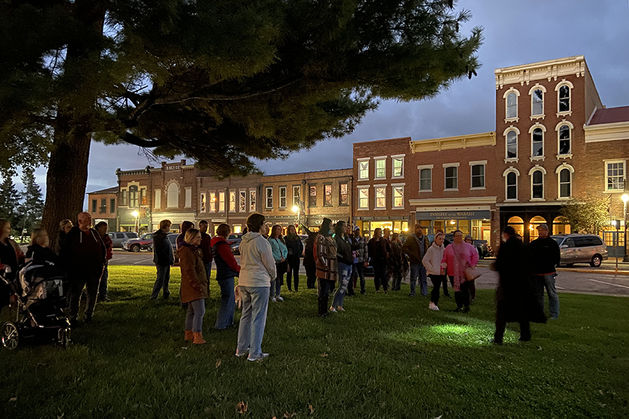 people gathering around downtown vincennes at night time