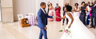 a bridal party cheering a dancing bride and groom