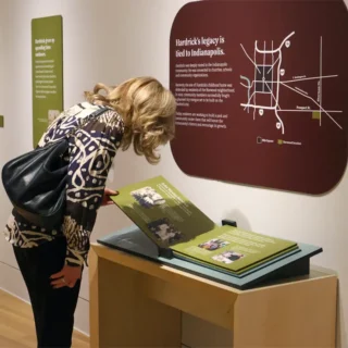 Woman uses flip book in Through the Eyes of an Artist exhibit at Indiana State Museum