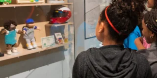 Girls looking at case with artifacts